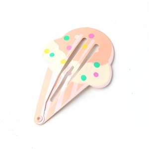 Detailed view of cream-colored ice cream shaped BB hair clip with colorful dots