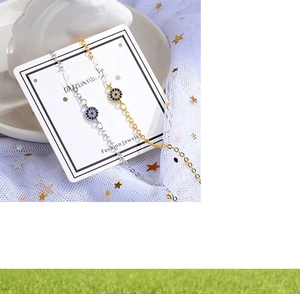 Detailed macro of gold and silver Evil Eye chain bracelets on elegant display cards