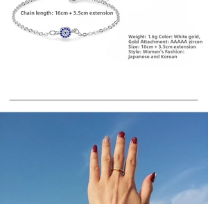 Detail of blue evil eye bracelet with AAAAA zircons and golden sunflower ring on hand