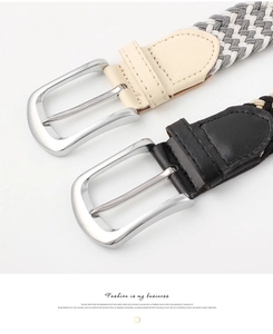 Detail of silver polished metal pin buckles on beige and black woven elastic belts