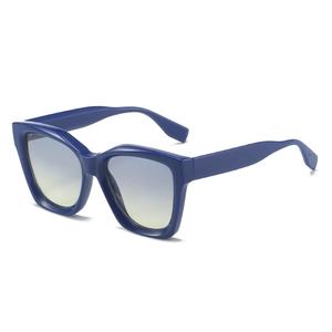 Modern Y2K cat-eye sunglasses with thick dark blue frame and gradient lenses