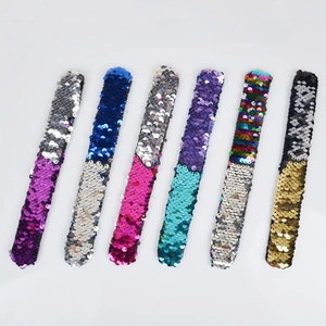 Detail showing set of six sequin slap bracelets with reversible flip color sequins