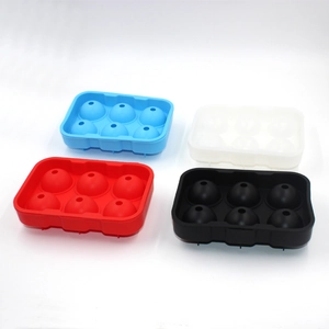 Detailed view of four silicone ice ball molds in blue, red, white, and black colors