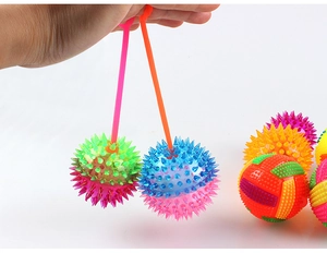 Detail of colorful spiky massage balls with elastic cords in various vibrant colors