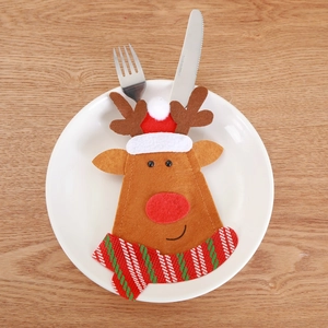 Detailed close-up of a felt reindeer cutlery holder with a striped scarf on a white plate