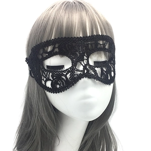 Close-up of intricate hollow-out lace patterns on the black masquerade eye mask