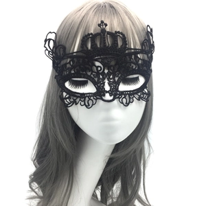 Close-up of black lace eye mask with crown design on a white mannequin head