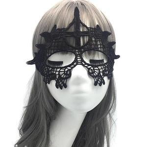 Detailed view of intricate black lace patterns and crown-shaped top on masquerade mask