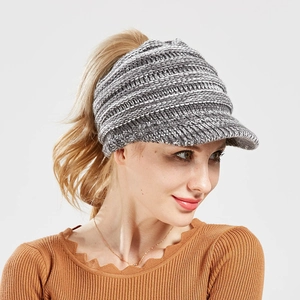 Close-up of grey knitted baseball cap with ponytail hole and wide brim for winter sports