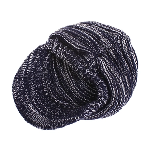 Detail view of navy and white knitted baseball cap with textured chunky yarn and short brim