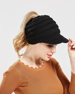 Side view of black chunky knit ponytail baseball cap featuring a convenient back opening
