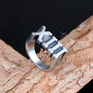 Vintage matte silver stainless steel ring with Roman numeral XIII on rough tree bark