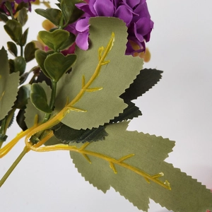 Detail of purple artificial hydrangea flowers and green leaves with yellow veins