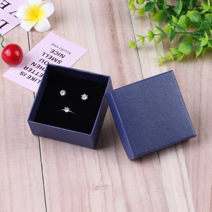 Blue linen texture jewelry gift box with silver cubic zirconia ring and stud earrings set