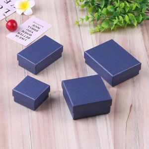 Deep blue linen texture jewelry gift boxes in square and rectangular sizes on wooden desk