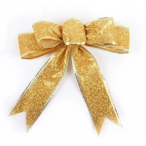 Close-up of golden glitter Christmas bow decoration for holiday gifts and tree ornaments