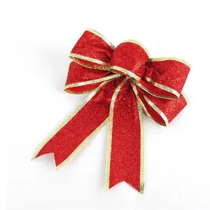 Detail of red glitter Christmas bow with gold wire edges for festive hanging decor