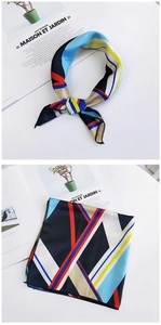 Detail view of geometric silk scarf with blue and red pattern against fashion magazine