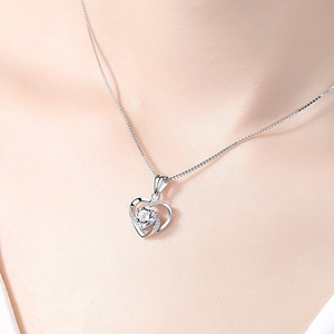 Elegant S925 sterling silver heart necklace featuring a rotating sparkling crystal pendant