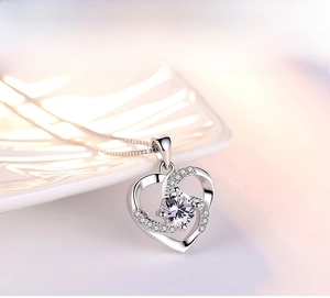 Close-up of silver S925 heart pendant necklace with shimmering central stone