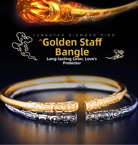 Detail of gold and gunmetal open bangles with intricate cloud relief carvings