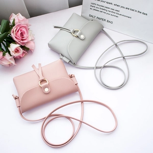 Mini pearl shoulder bags in gray and pink faux leather with gold ring hardware