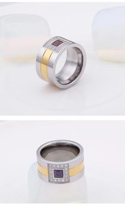 Detail of wide two-tone titanium ring with square purple gems and micro-pave crystals