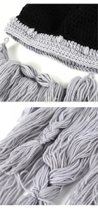 Close-up of handmade Viking style knitted beanie with black and grey fringe texture