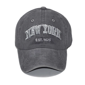 Detailed close-up of white 3D embroidery and vintage washed cotton texture on baseball cap