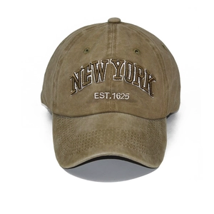 Close-up of vintage brown washed cotton baseball cap with New York 3D embroidery detail