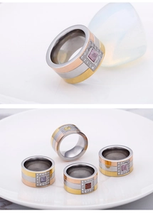 Detailed view of tricolor titanium steel wide rings with square gemstone inlays
