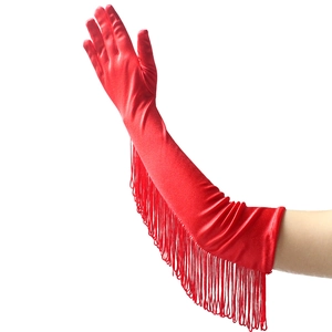 Detail of red satin long gloves with elegant tassel fringe for latin dance performances