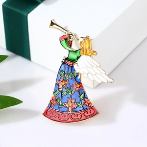 Enamel angel brooch playing trumpet in gold finish presented on white gift background