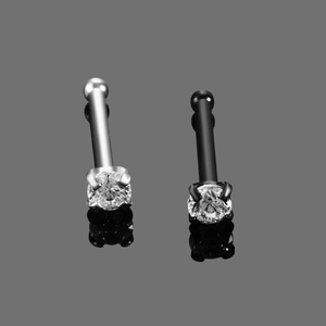Macro shot of silver and black stainless steel nose studs with round cubic zirconia stones