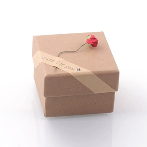 Detail of square kraft paper jewelry box with red paper flower and Just for you label