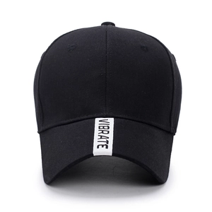 Black cotton baseball cap with white vertical VIBRATE brand tape on curved brim