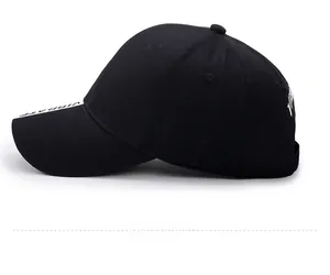 Side view detail of black cotton baseball cap with white VIBRATE lettering embroidery