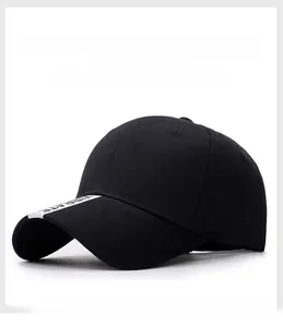 Detail of black cotton baseball cap with white VIBRATE lettered tape on the brim
