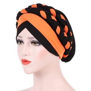 Detail of two-tone orange and black braided headwrap showing textured fabric weave