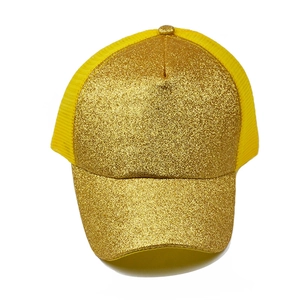 Detailed view of shiny gold sequins and breathable yellow mesh on a ponytail baseball cap