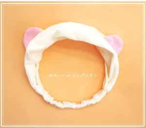 Close-up of soft plush cat ear headband with elastic band for skincare and makeup