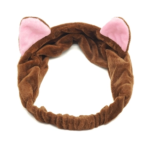 Close-up of soft brown plush cat ear headband with pink inner lining for face washing