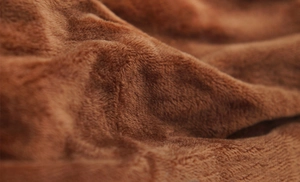 Macro shot of soft brown plush coral fleece fabric showing fluffy texture on cat headband