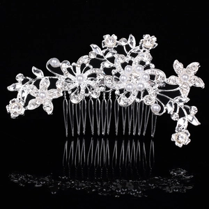 Elegant silver bridal hair comb with floral rhinestone patterns and pearls on black background