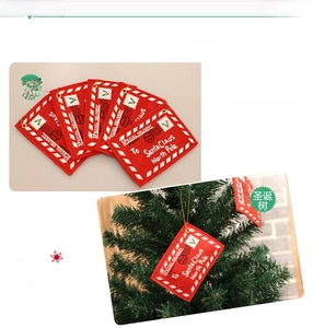 Detail of red felt Christmas envelope ornaments with white festive North Pole stamps