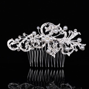 Silver bridal hair comb featuring pearls and rhinestones in an elegant floral leaf design