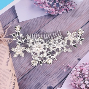 Detailed view of bridal hair comb with pearls and rhinestones on a vintage background