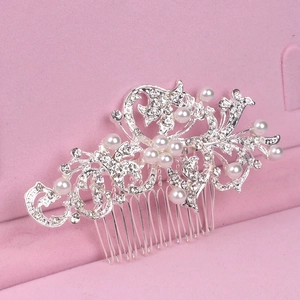 Macro view of bridal silver metal hair comb with rhinestones and pearls in a gift box