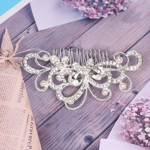Macro detail of bridal hair comb with silver alloy flowers, rhinestones and pearls
