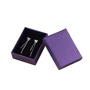 Silver butterfly tassel earrings displayed in a luxury purple textured gift box